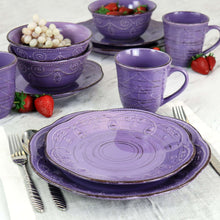 Purple stoneware dinnerware set with embossed designs: bowls, plates, and mugs