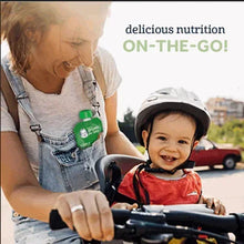 Baby in a helmet smiling as a caregiver feeds with a spoon