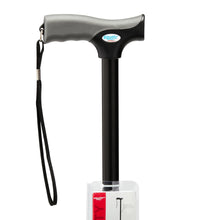 Black walking cane handle with cushioned grip and wrist strap, close-up
