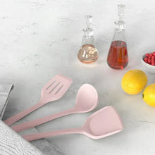 Pink silicone cooking tools set with slotted spatulas and whisk