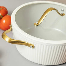 White ribbed Dutch oven with gold side handle and domed lid