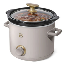 Manual slow cooker with taupe body, glass lid, gold knob controls