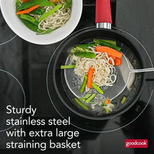 Spider wok strainer lifting vegetables from a wok; round mesh basket on long handle