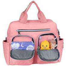 Pink diaper bag tote with two separated front compartments holding baby items