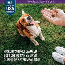 Hickory smoke soft chews offered to a dog by a hand
