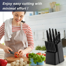 Chef knife and black knife block on countertop with chopped vegetables and herbs