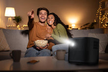 RCA home theater projector with front lens glowing, black vented design