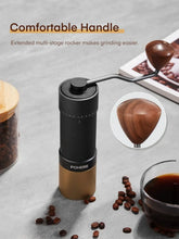 Manual coffee grinder with rocker handle, black and gold body, conical burr chamber