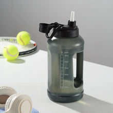 Translucent black water bottle with straw in lid, carry handle, and 64oz markings