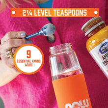 Amino-9 essentials powder jars with scoop holding level teaspoons on pink cloth