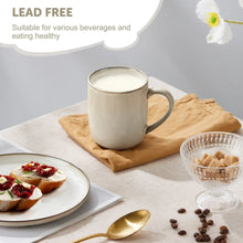 Cream ceramic coffee mug with handle on table with food and cookies