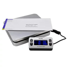 Digital shipping scale with envelope on platform and blue display reading 0.06