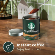 Starbucks Premium instant coffee can with spoonful coffee grounds and open lid