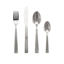 Stainless steel flatware set with forks, knives, spoons, and serving spoon