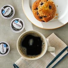 Espresso roast coffee cup with dark brew and used coffee pods