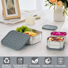 Stainless steel lunch containers with grey silicone lids, one open with vegetables