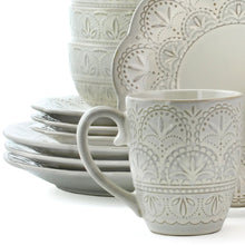 Stoneware mug with embossed floral pattern and curved handle, off-white