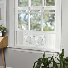 White window fan installed in window with two front circular fan grills