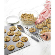 Stainless steel turner and spoon with dark nylon heads for serving baked foods