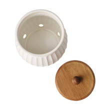 Stoneware onion keeper base with ridged sides, removable lid with wooden knob