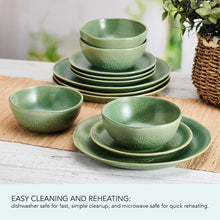 Green stoneware dinnerware set with embossed leaf design, bowls and plates on table
