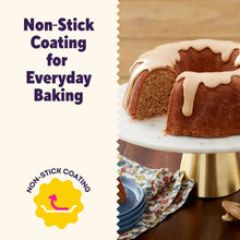 Bundt cake with white icing and sliced piece on a plate