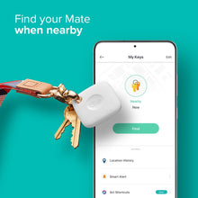 White Bluetooth tracker on keys with a smartphone displaying a nearby location screen