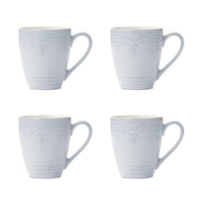 Blue stoneware mugs with embossed floral medallion and scroll border