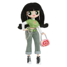 Character doll wearing green top, gray jeans, belt, chain, and pink heart shoulder purse.