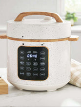 Speckled white electric pressure cooker with touch control display and wooden handle