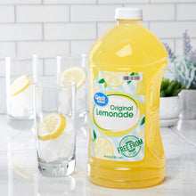 Original lemonade bottle with serving glasses, yellow drink, white cap