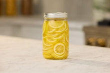 Clear glass Mason jar with airtight lid, filled with lemon slices