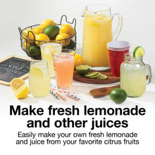 Electric citrus juicer with clear pitcher and yellow lid beside citrus drinks