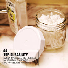 White tough-top canning jar lids on clear glass jars, with matching spare lid