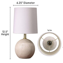 Mini table lamp with light fabric shade, textured ball base, and 12.5 in height