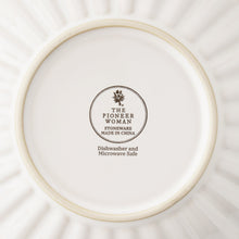 Cream stoneware dinner bowl base with The Pioneer Woman logo and safety text