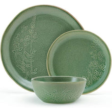 Green stoneware plates and bowls with embossed botanical pattern and matching glaze