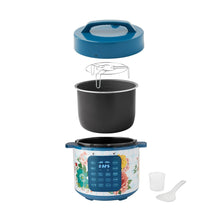 Teal pressure cooker with open lid and removable inner pot