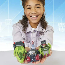 Transformers robot action figures in hands: green and silver armored bots