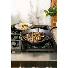 Square cast iron skillet with short handle, holding grilled meat on ridged surface.