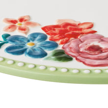Ceramic serving board edge with painted pink, blue, and red flowers on mint green base