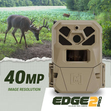 Beige cellular trail camera with front lens window and side mounting straps.