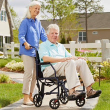 Blue transport wheelchair with black seat and back, swing-away footrests, used outdoors on pavement