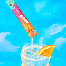 Orange Kiss energy drink mix stick being poured into a glass