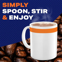 White mug of creamy decaf coffee with orange band, with coffee beans