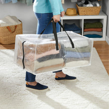 Clear moving storage bag with black handles and straps, open top