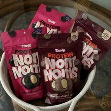 Tandy Protein Noms snack pouches in a bowl: salted caramel crunch and chocolate churro
