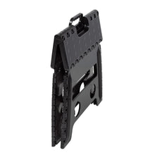 Black plastic folding step stool angled view showing stacked folding hinges