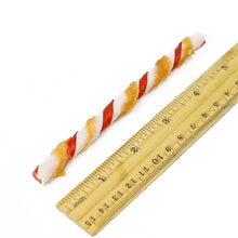Chicken-flavored twisted dog treats next to a 9 inch ruler