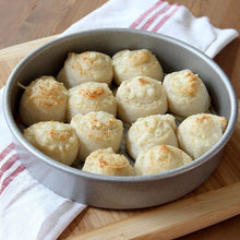 Bowl of garlic-roasted potatoes sprinkled with herbs